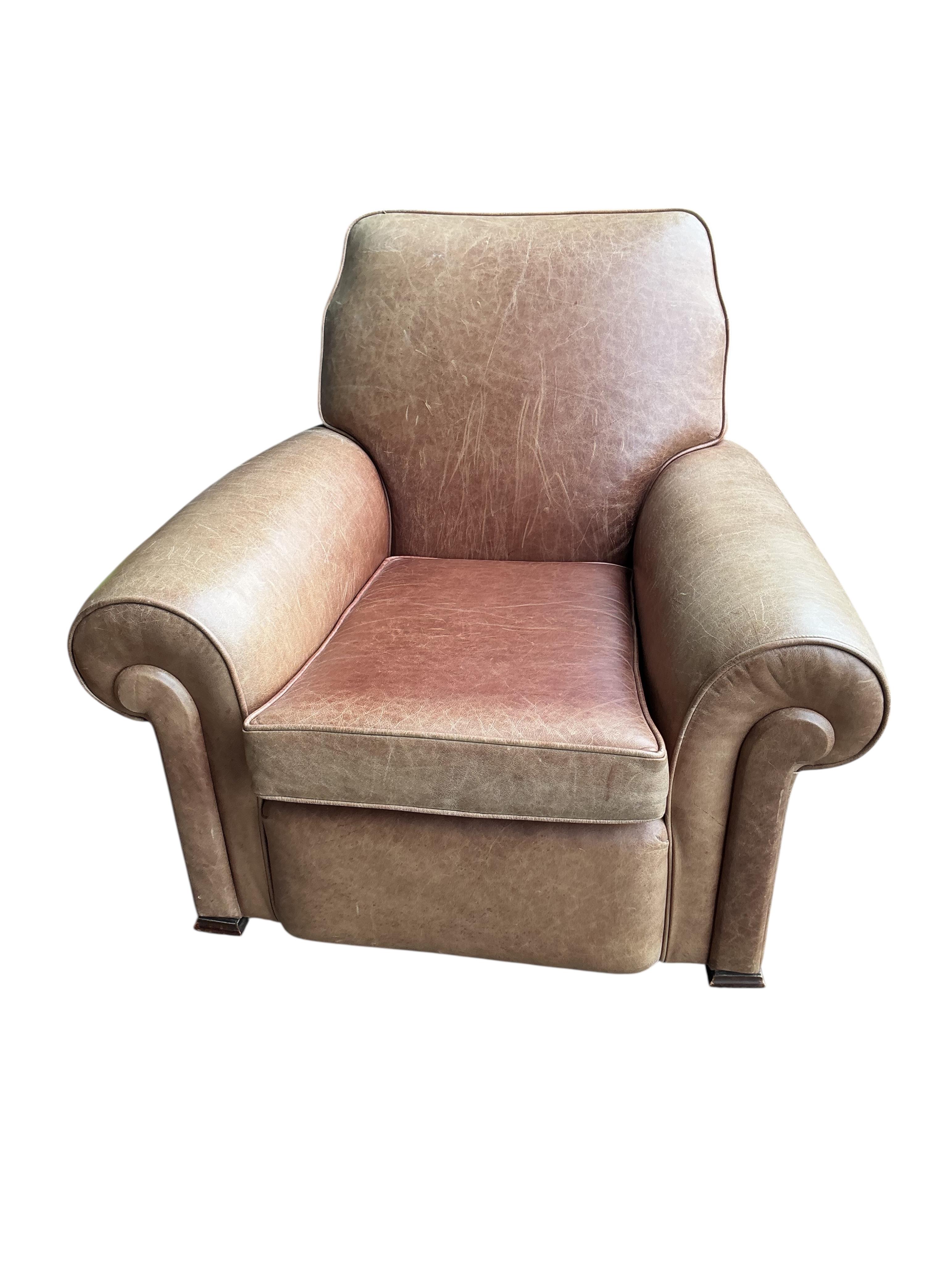 A pair of early 20th century tan leather club chairs, width 94cm, depth 78cm, height 80cm